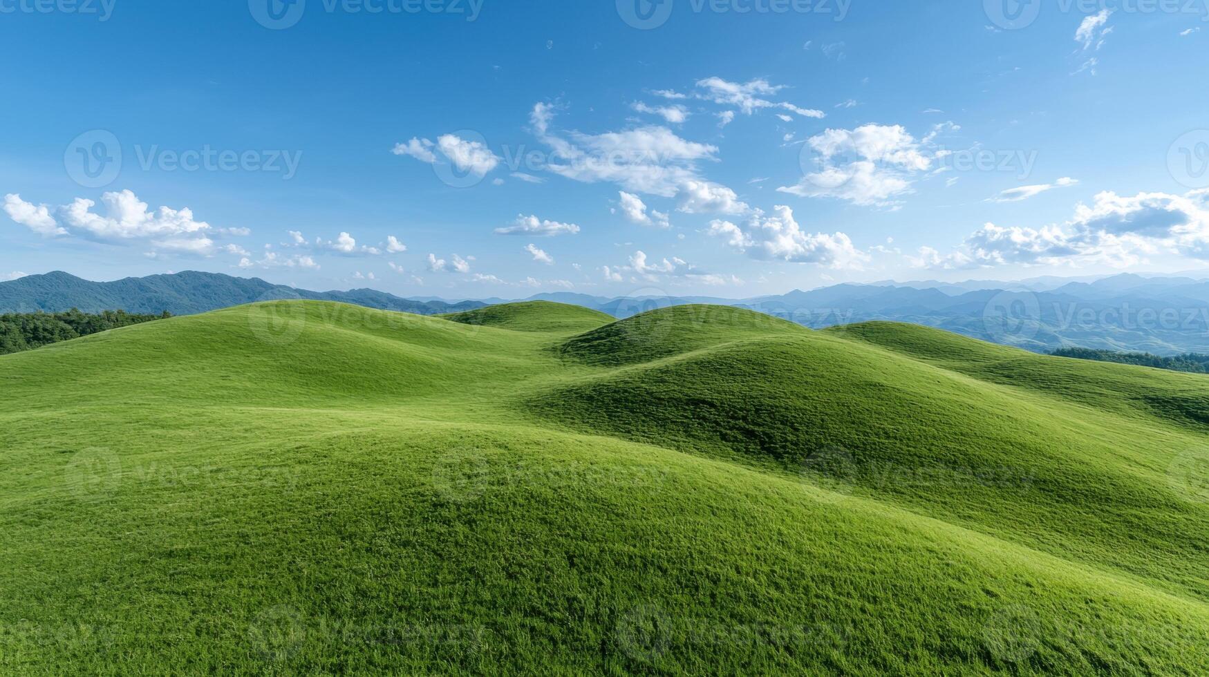 Rolling green hills under a bright blue sky photo
