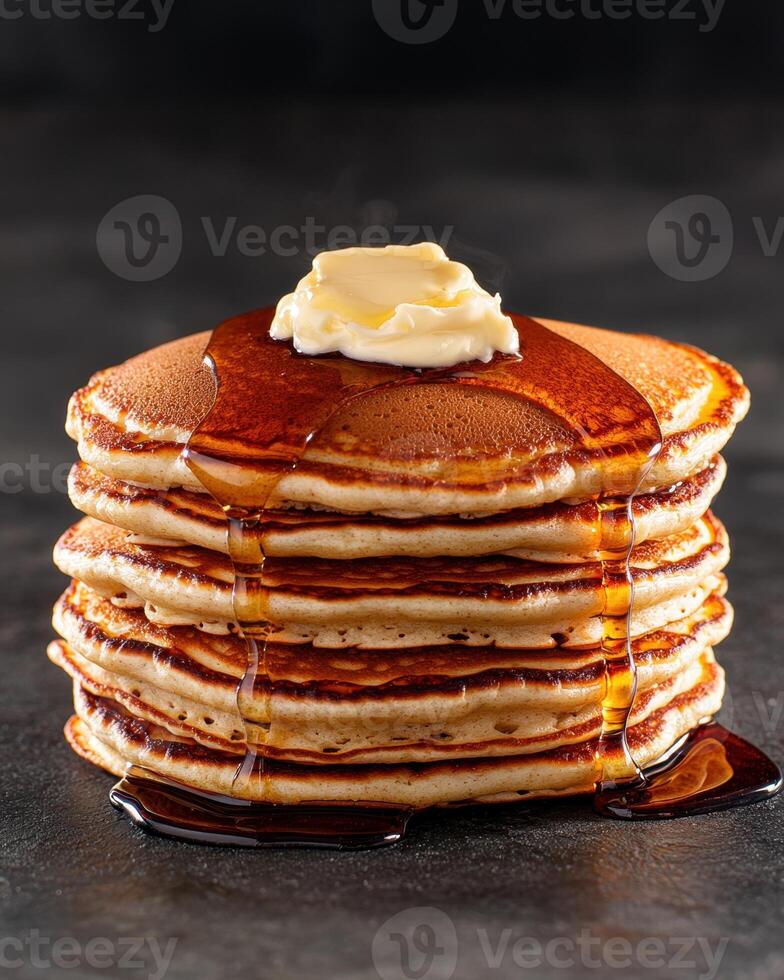 Stack of fluffy pancakes with butter and syrup photo