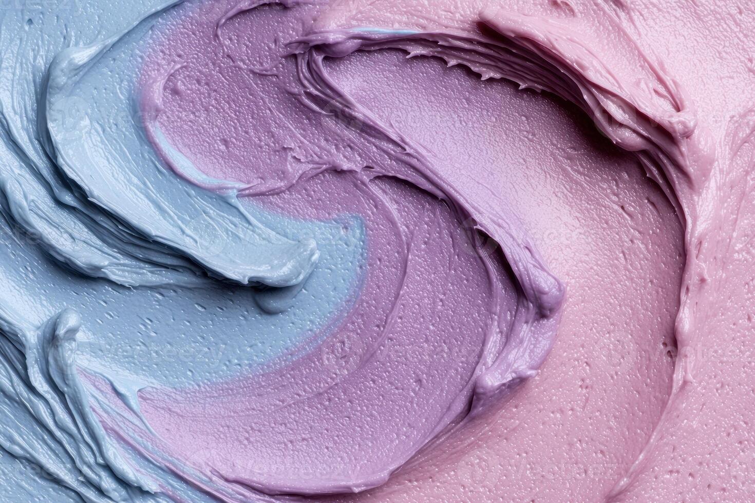 A close up of a blue and pink frosting photo