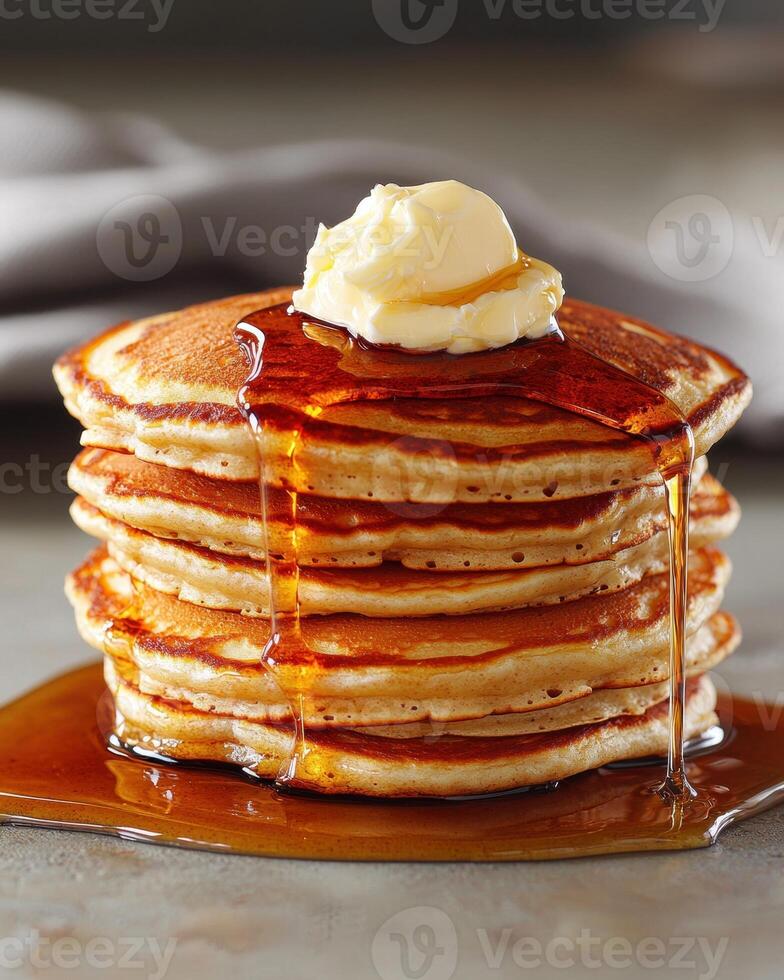 Stack of fluffy pancakes with butter and maple syrup photo