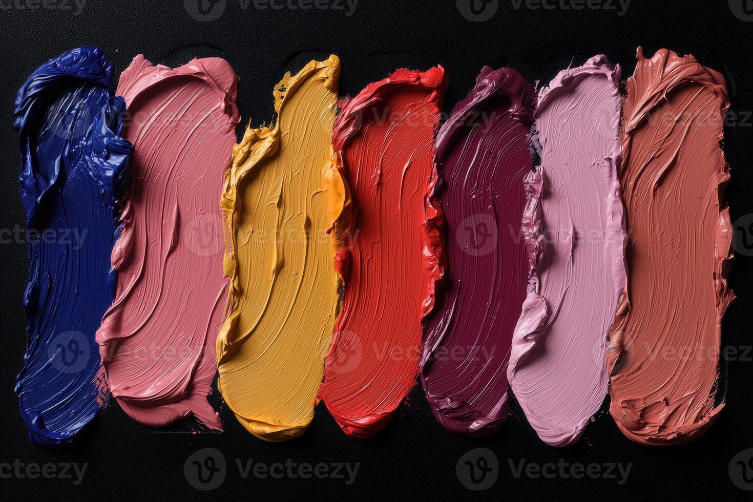 A group of different colored lipsticks on a black background photo