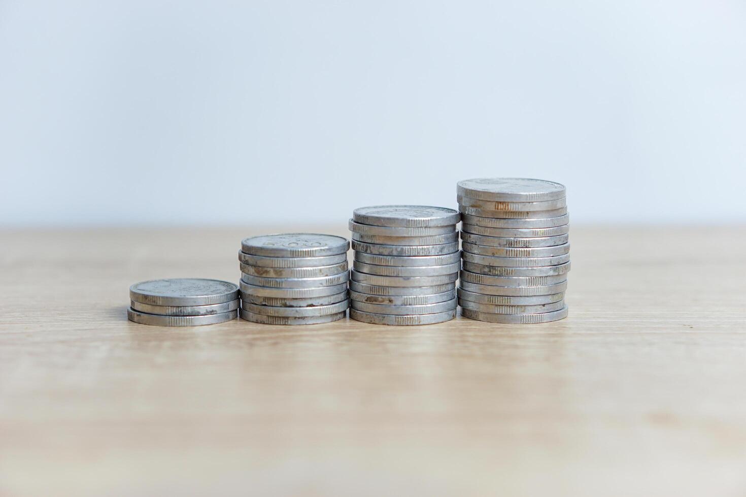 Close-up photo of a pile of coins on a table with a white background