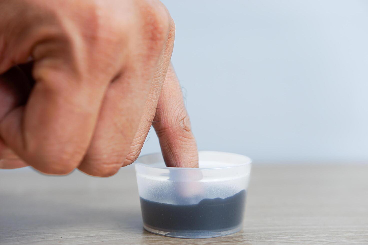 A man's little finger dipped in ink after voting in the Indonesian presidential election photo