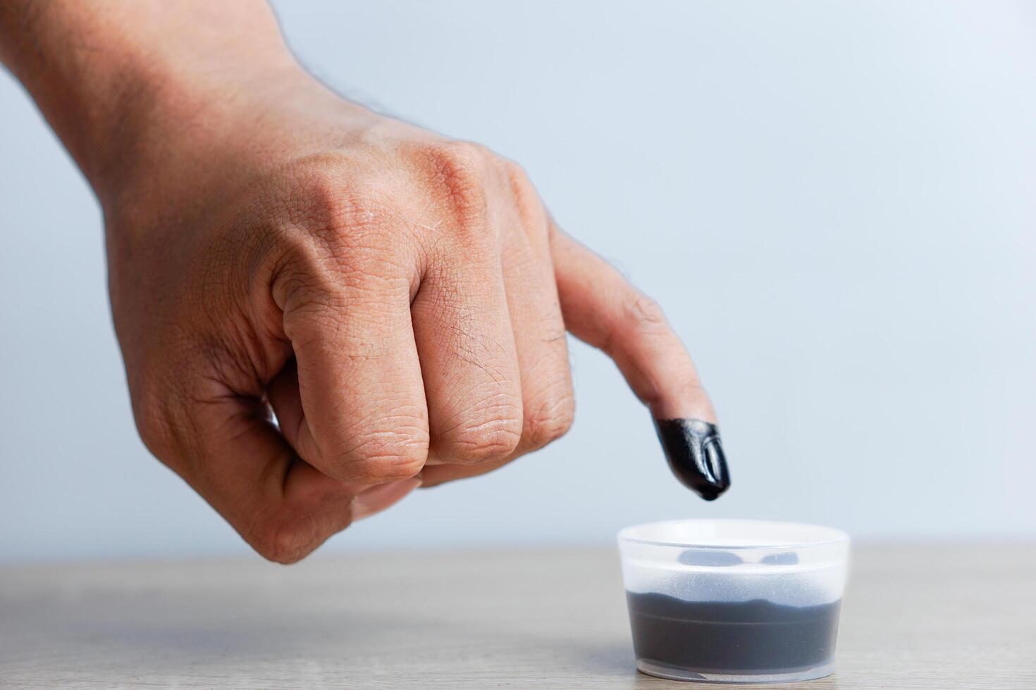 A man's little finger dipped in ink after voting in the Indonesian presidential election photo