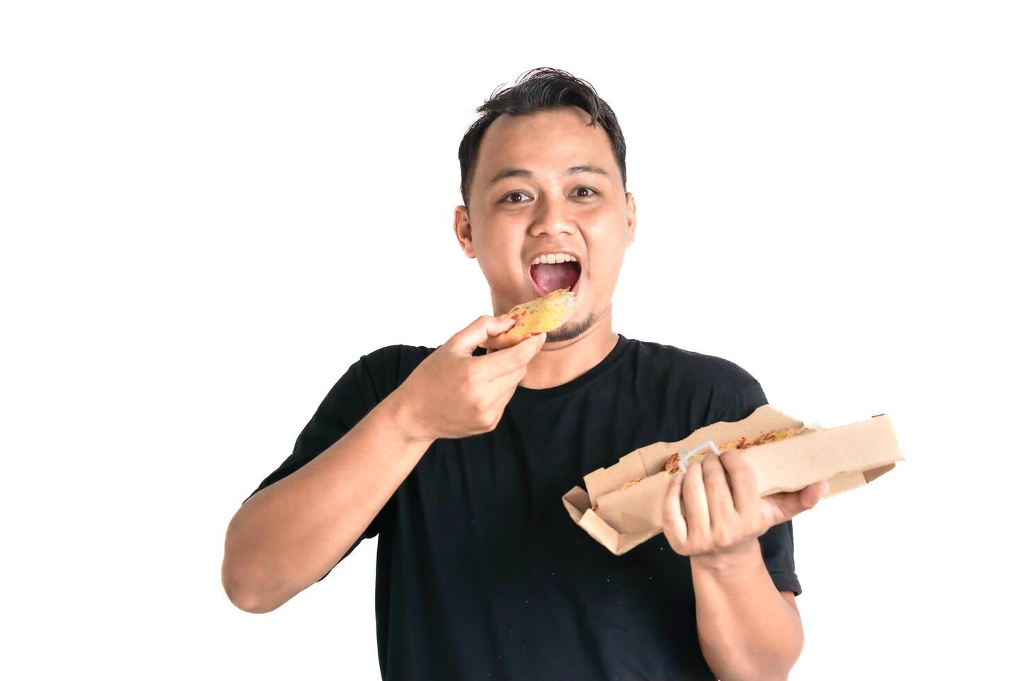 A man wearing a black T-shirt savors a tasty slice of pizza with a big smile photo