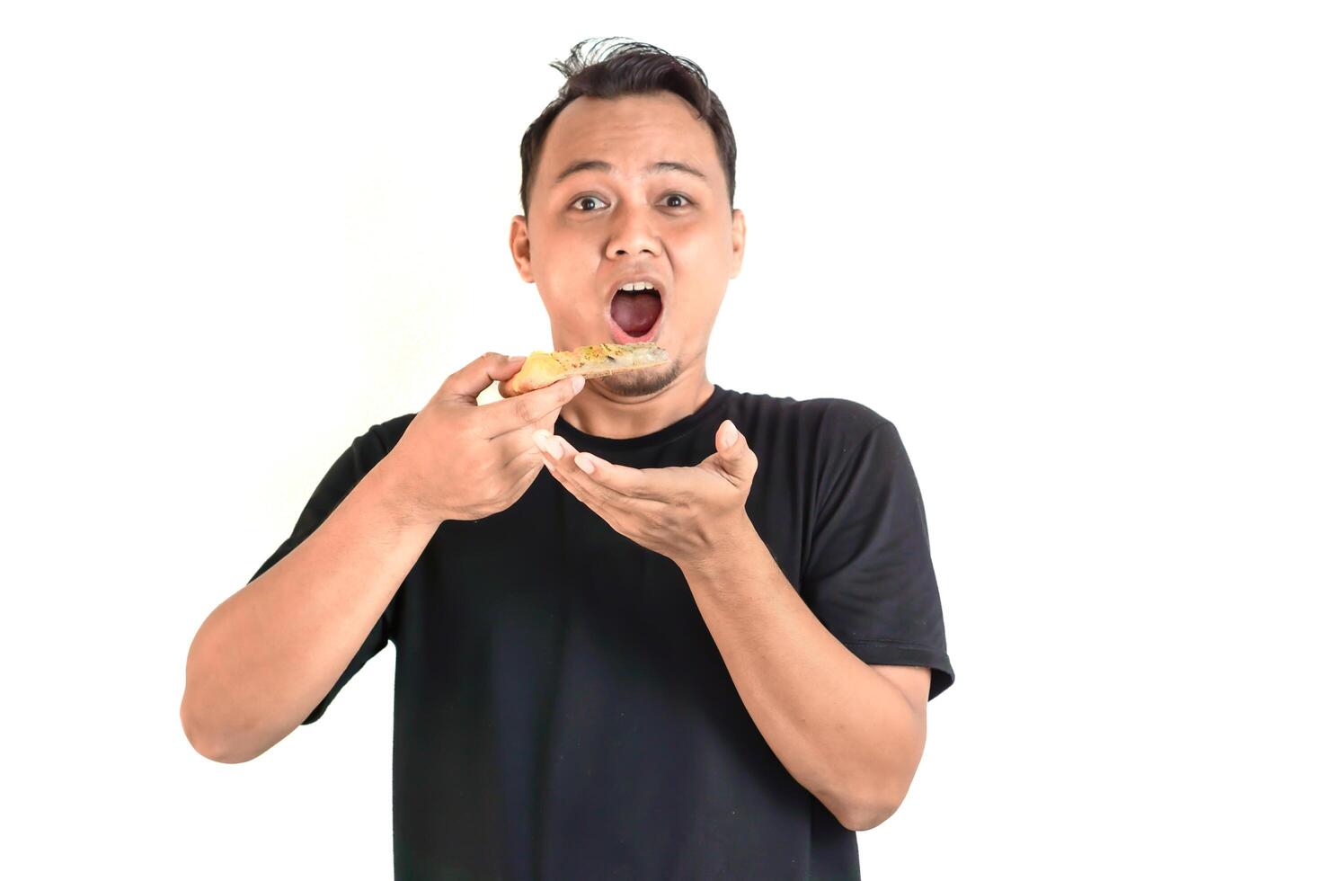 Enjoying a Delicious Slice of Pizza in a Black T-Shirt photo