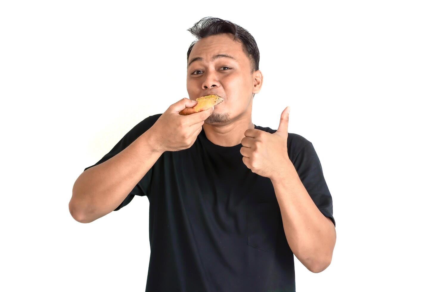 Man Enjoying a Delicious Snack with a Thumbs Up photo