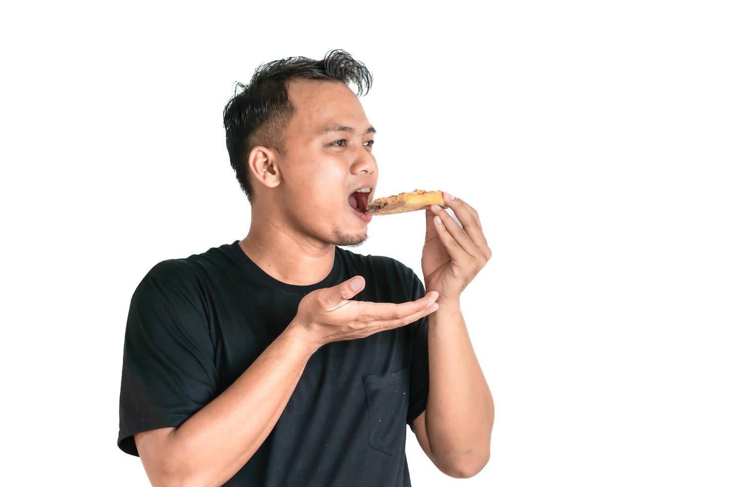 Portrait of an Asian Man Enjoying a Slice of Pizza in a Black T-shirt photo