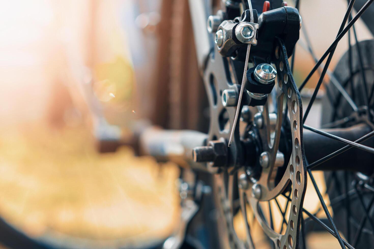 selective focus Close-up of a bicycle disc brake system, highlighting the rotor and caliper with blurred background. photo