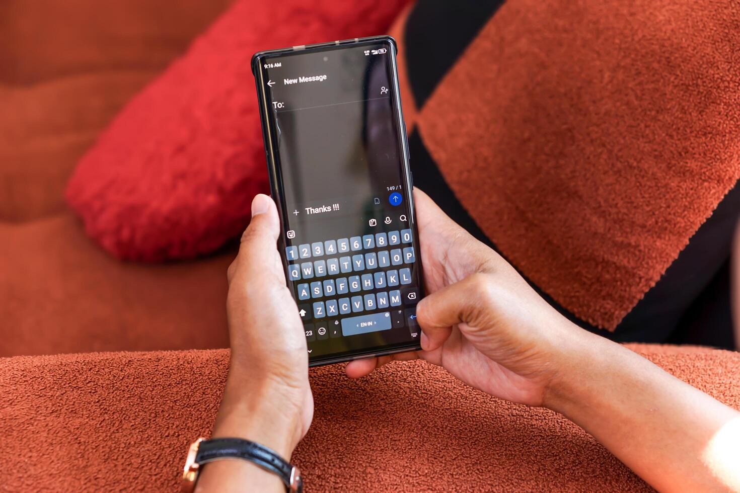A person typing a thank you message on their smartphone, showcasing digital communication's convenience. photo