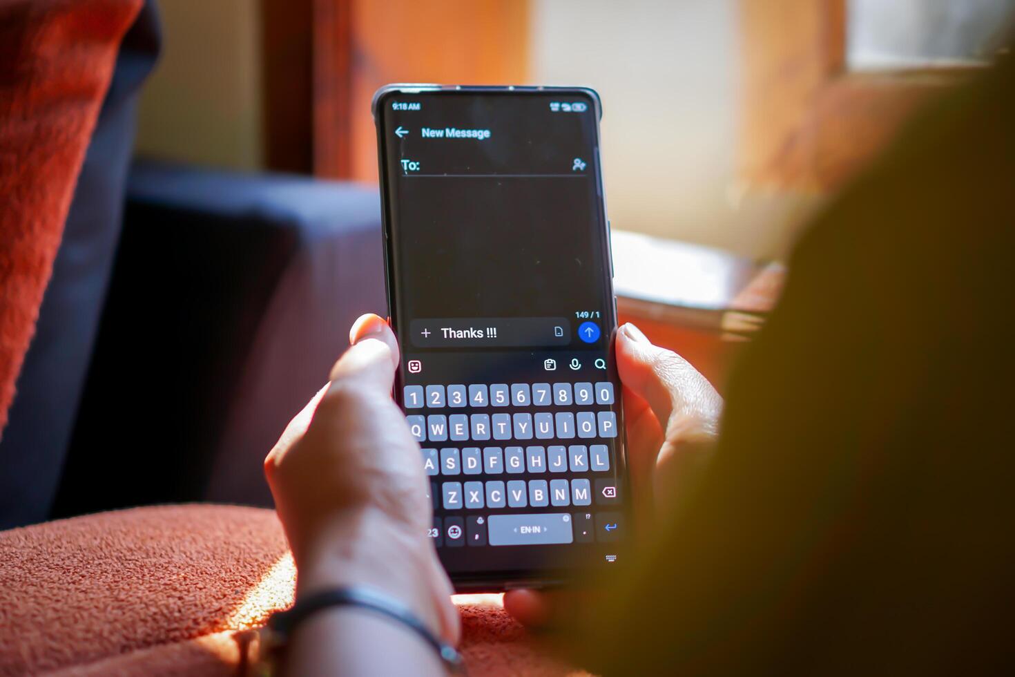 A person typing a thank you message on their smartphone, showcasing digital communication's convenience. photo