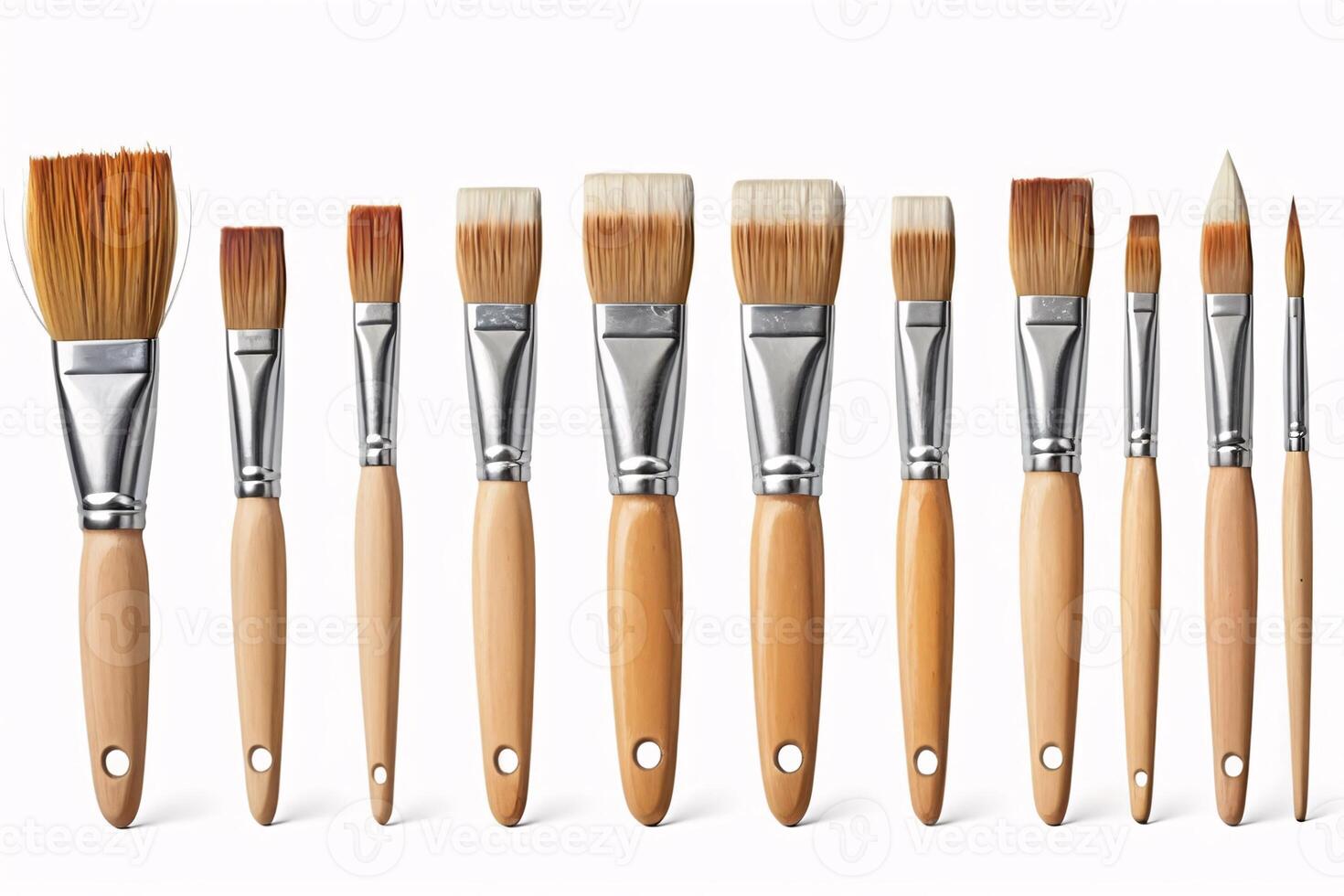 A set of nine different sized paintbrushes with wooden handles and silver ferrules. photo