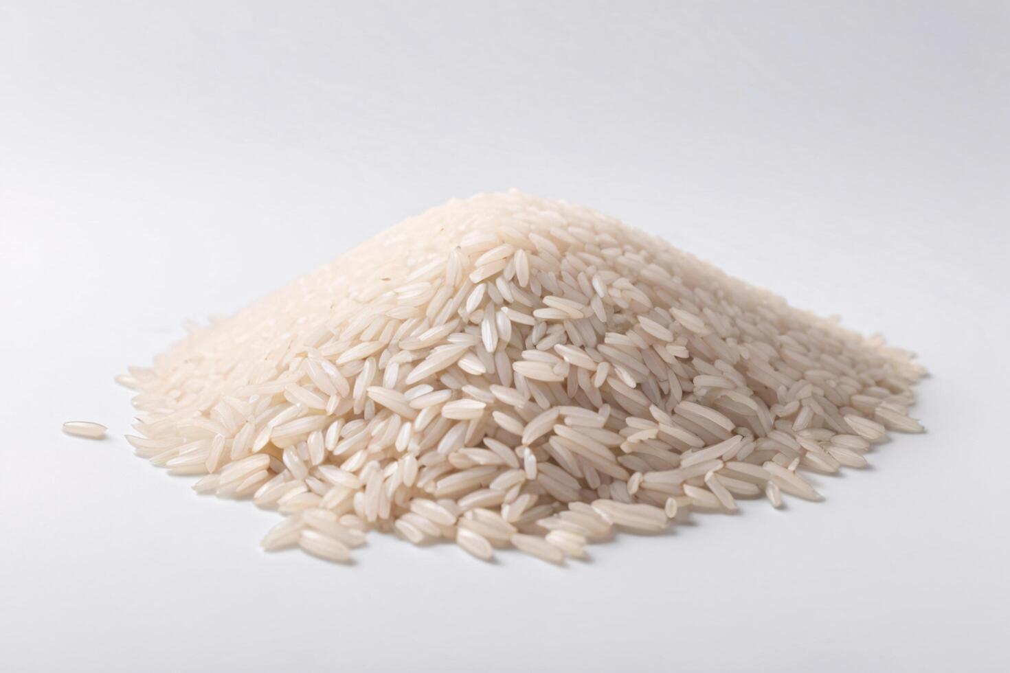 Pile of uncooked white rice on white background. photo
