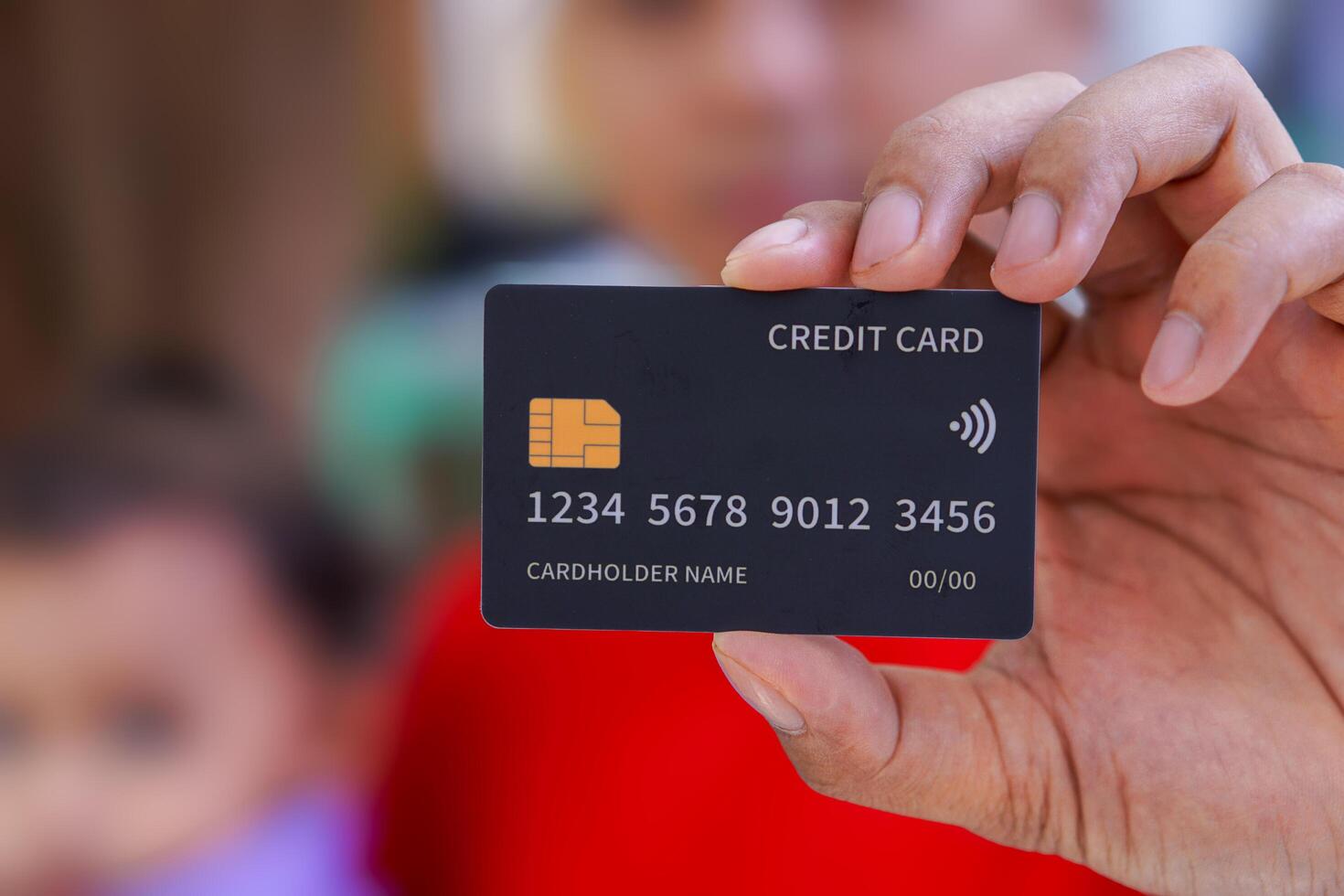 a close-up view person holding a credit card photo