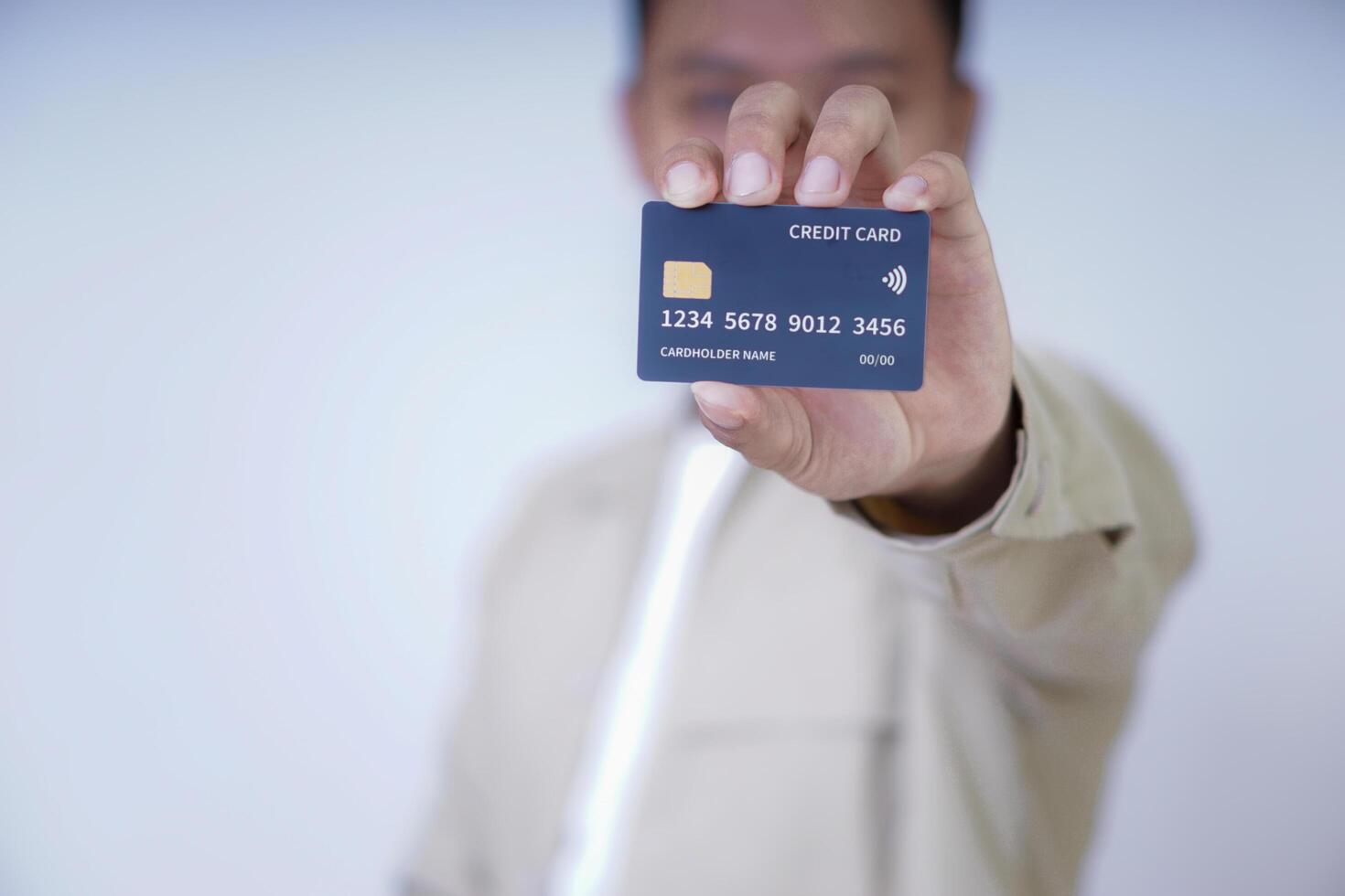 A person holding a credit card, showcasing its features and design for a photo. photo
