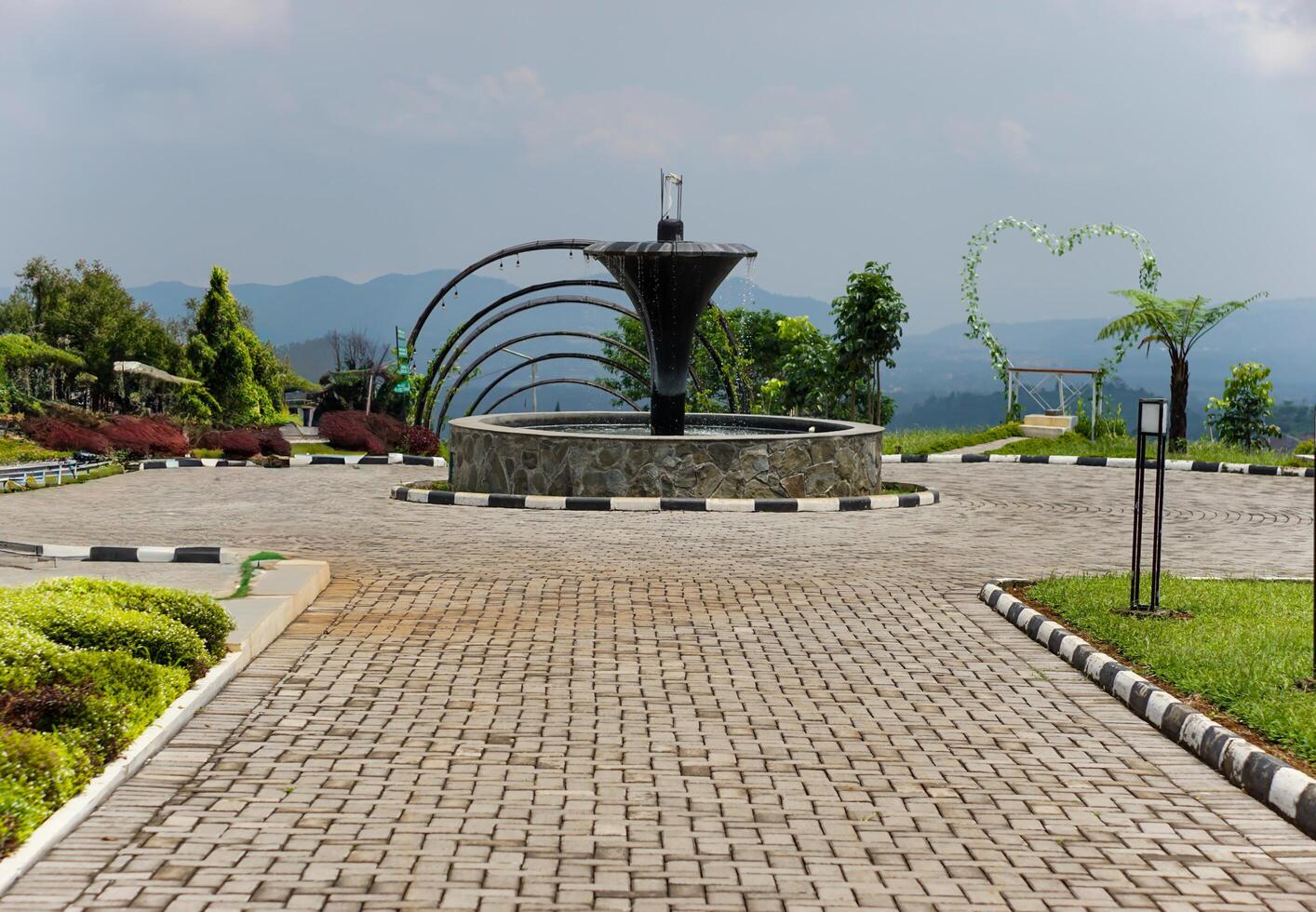 A peaceful garden with a fountain and scenic views photo