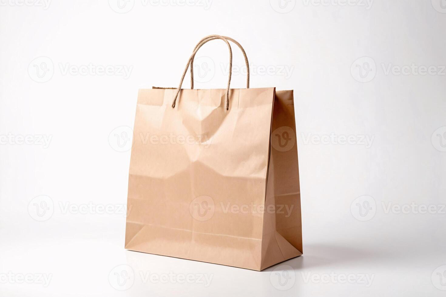 Brown paper bag with twisted paper handles on white background. photo