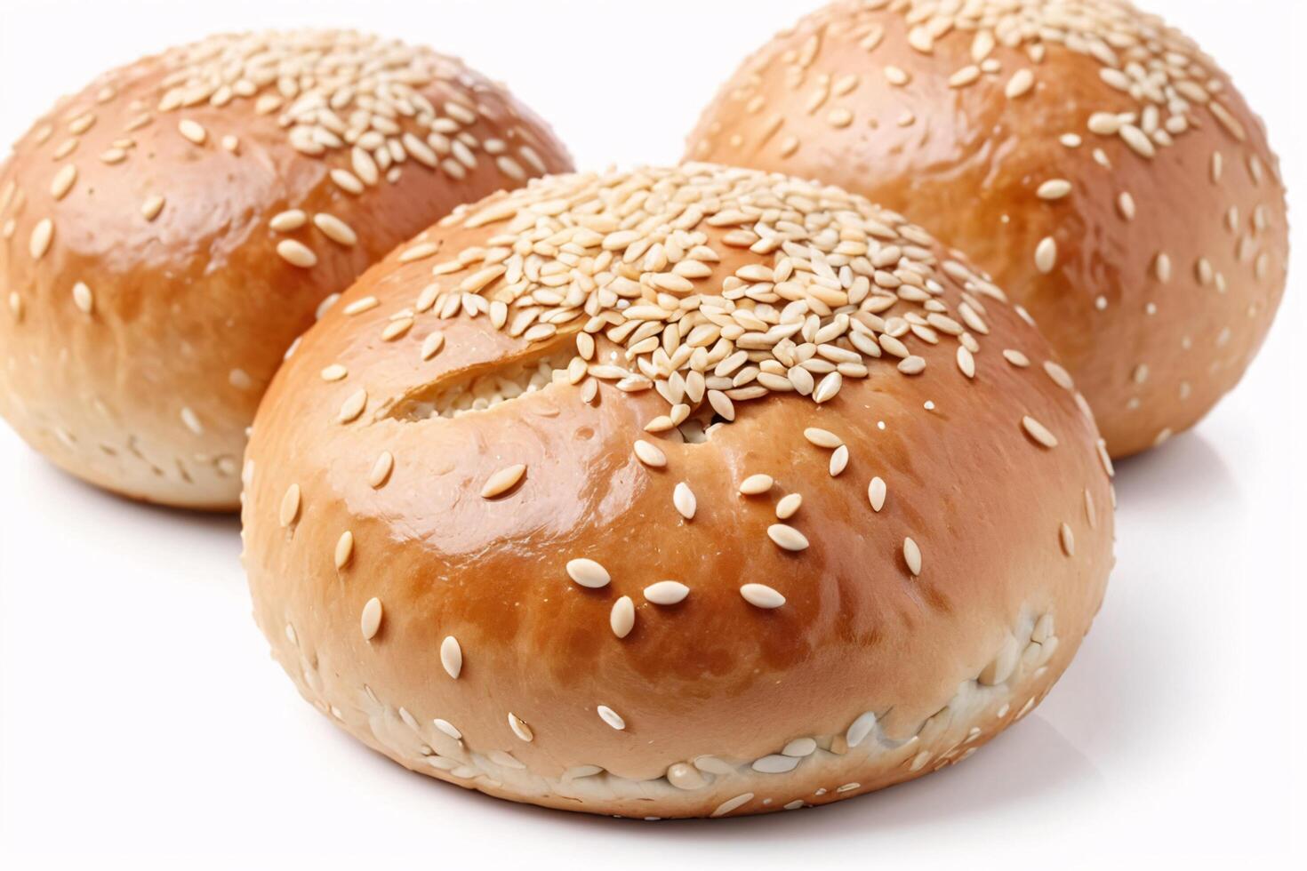 Three freshly baked burger buns topped with sesame seeds. photo