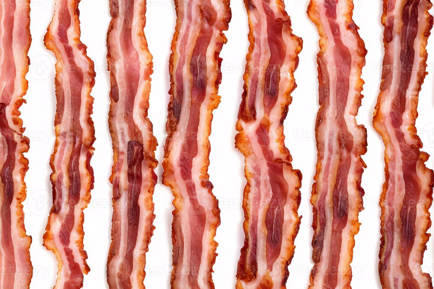 Close-up of crispy cooked bacon strips isolated on a white background. photo