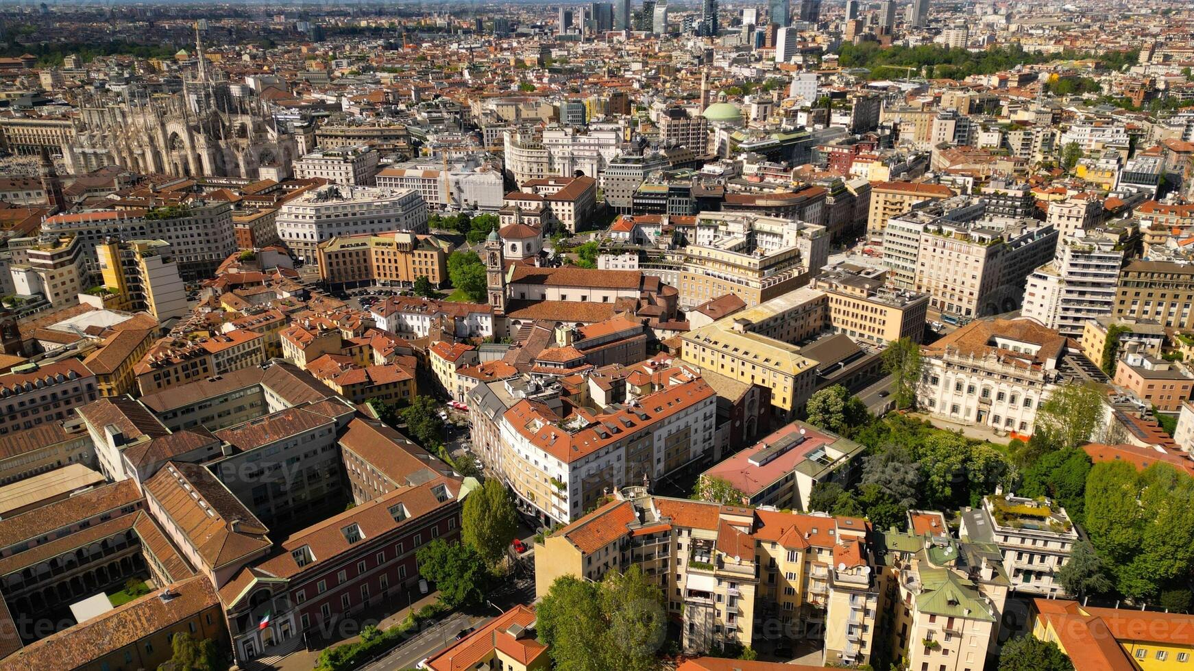 Roof of the University of Milan and city buildings top down view. Milan cityscape against a background of blue sky, view from above in sunny weather photo