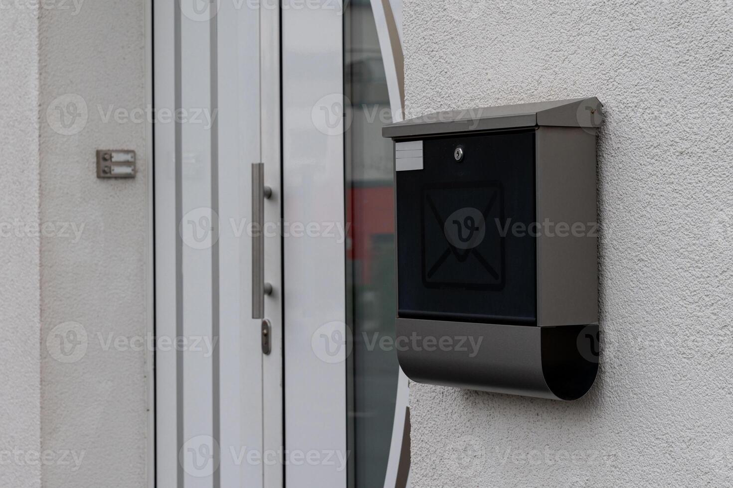 Modern mail box attached to a stylish door at an urban residence photo
