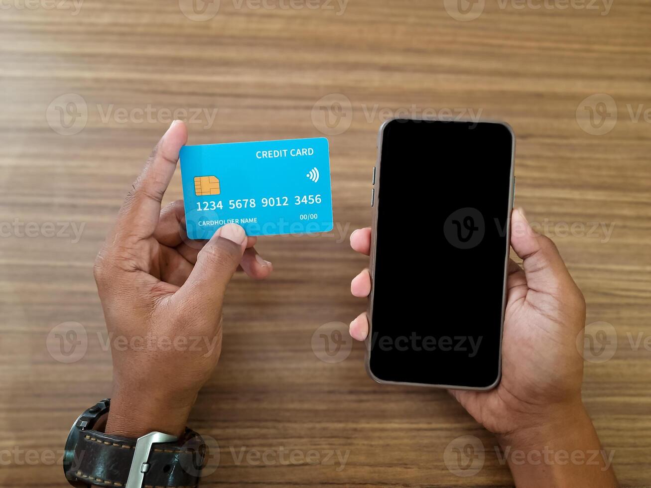 Man Holding Credit Card and Smartphone photo