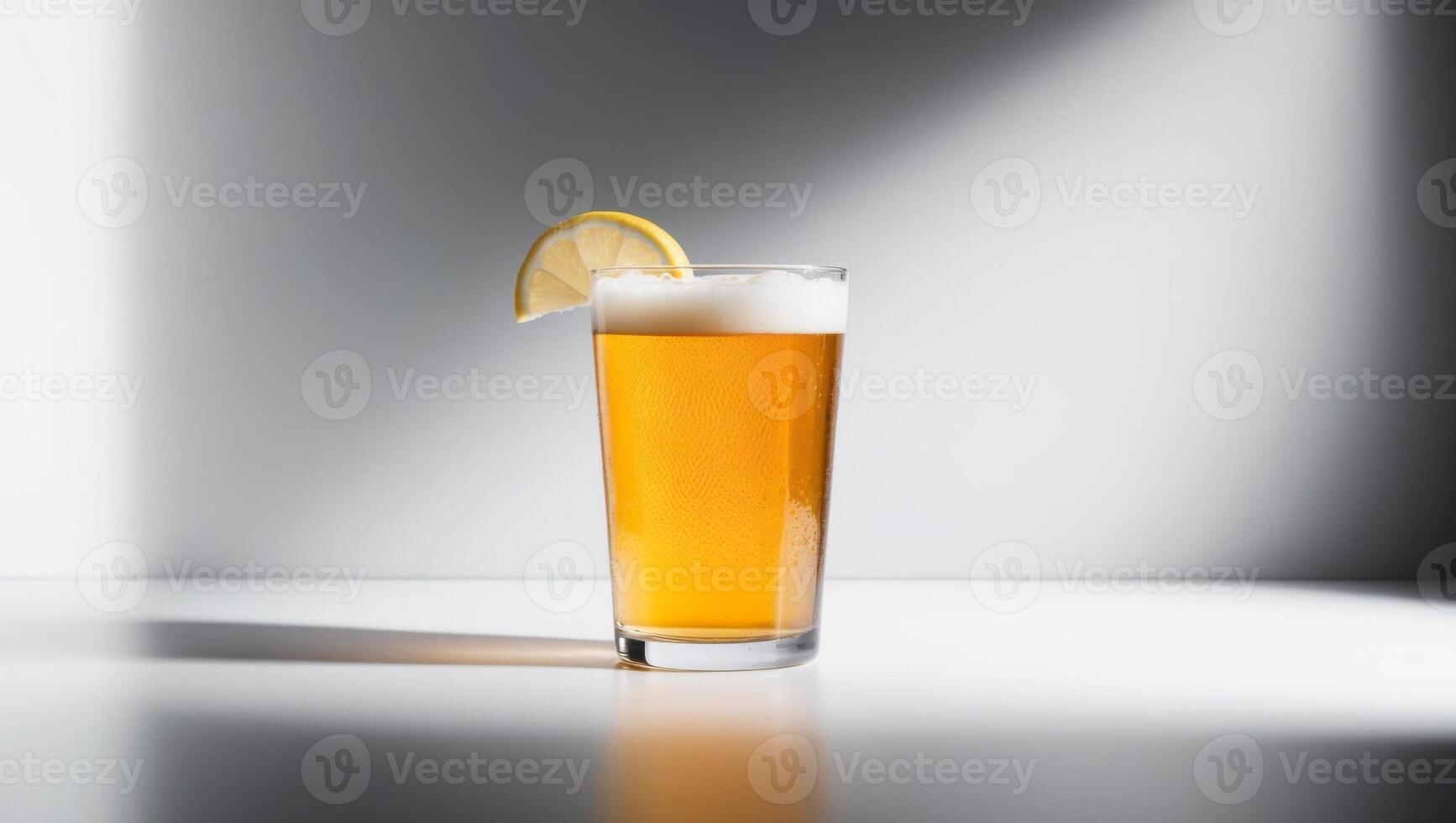 A glass of beer with a lemon slice on top photo