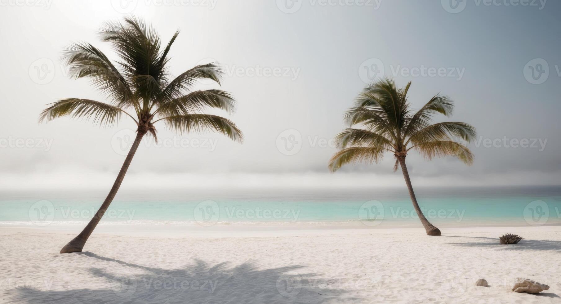 Two palm trees stand on a white sandy beach photo