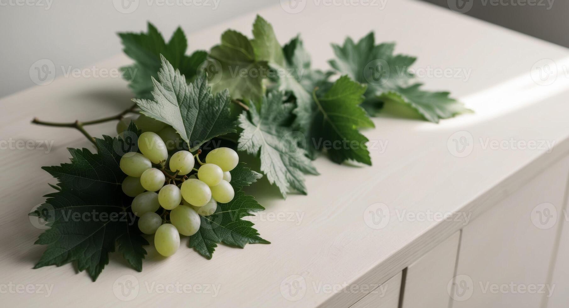 A bunch of grapes on a white table photo
