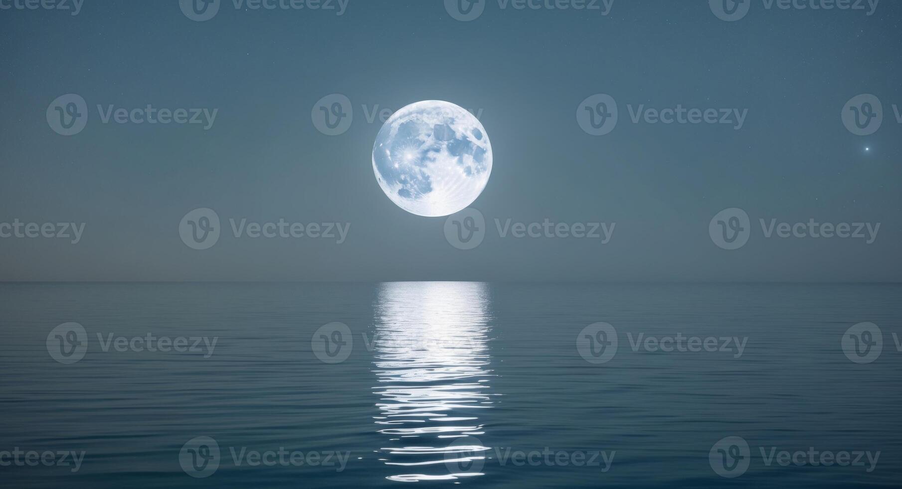A full moon is seen over the ocean photo