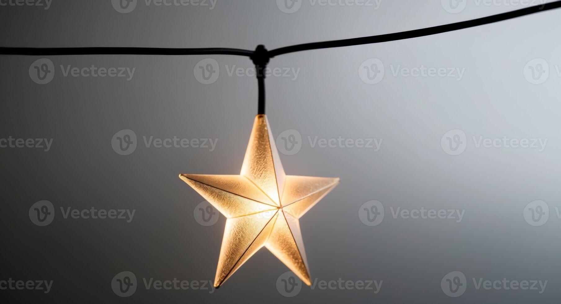A star shaped light hanging from a string photo