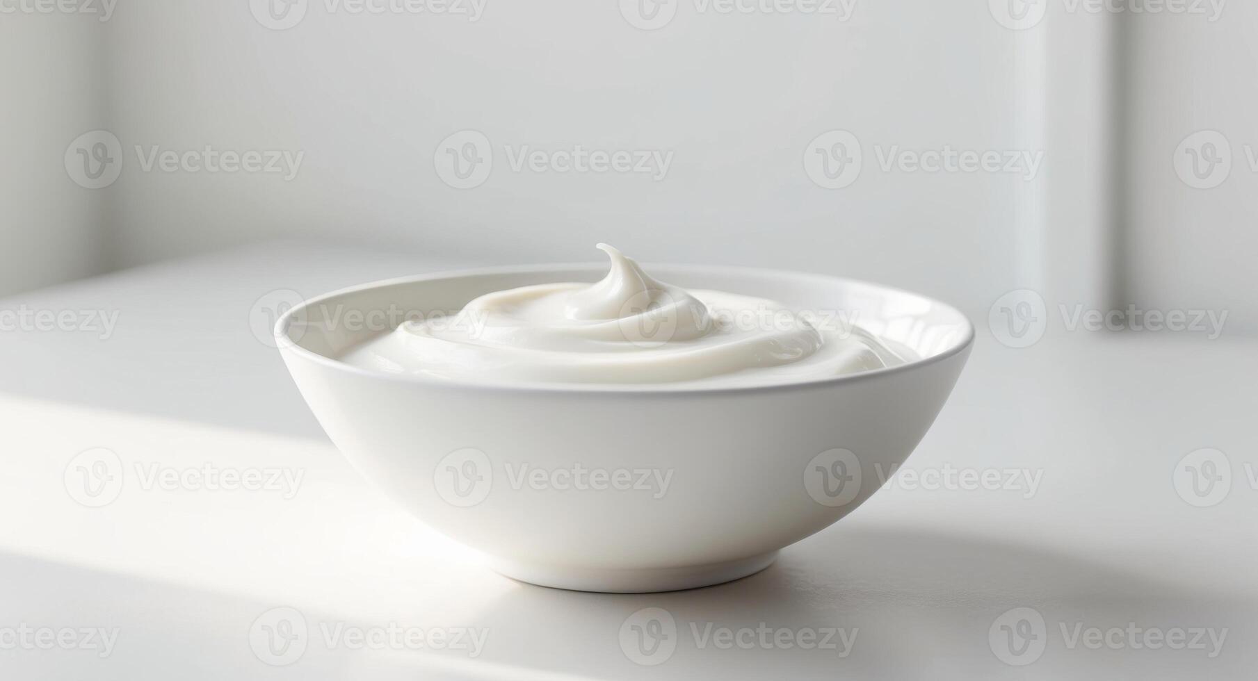 A bowl of yogurt sitting on a table photo