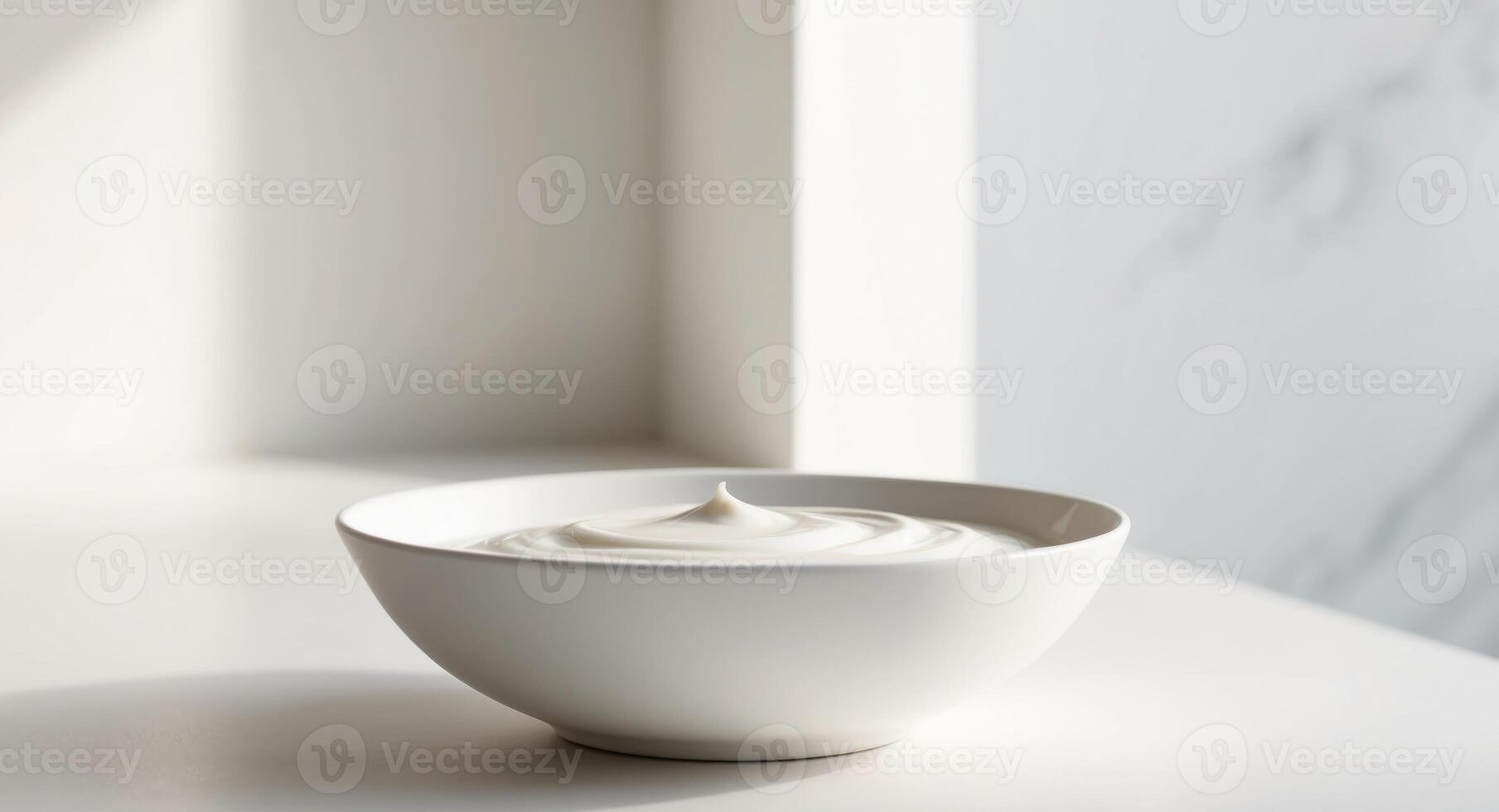 A bowl of yogurt sits on a table photo