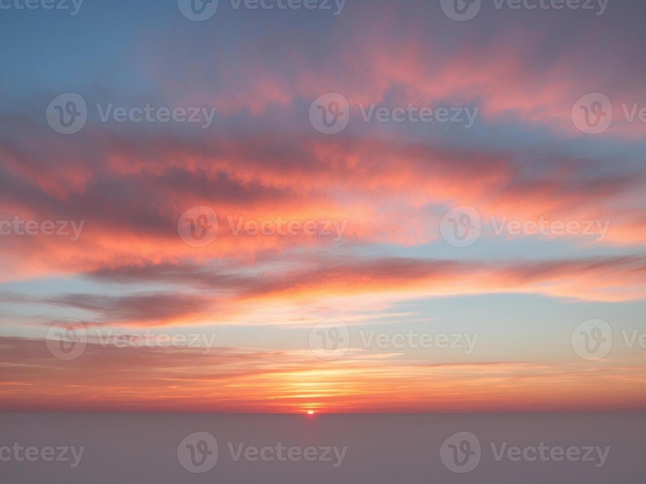 A sunset over the ocean with clouds photo