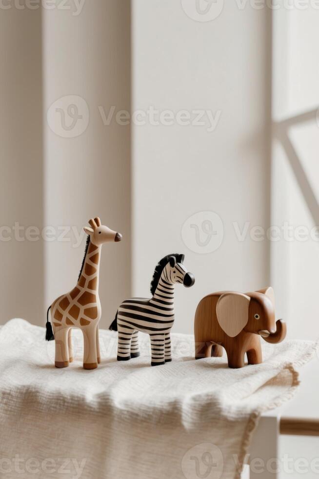 A wooden toy giraffe, zebra and elephant on a table photo