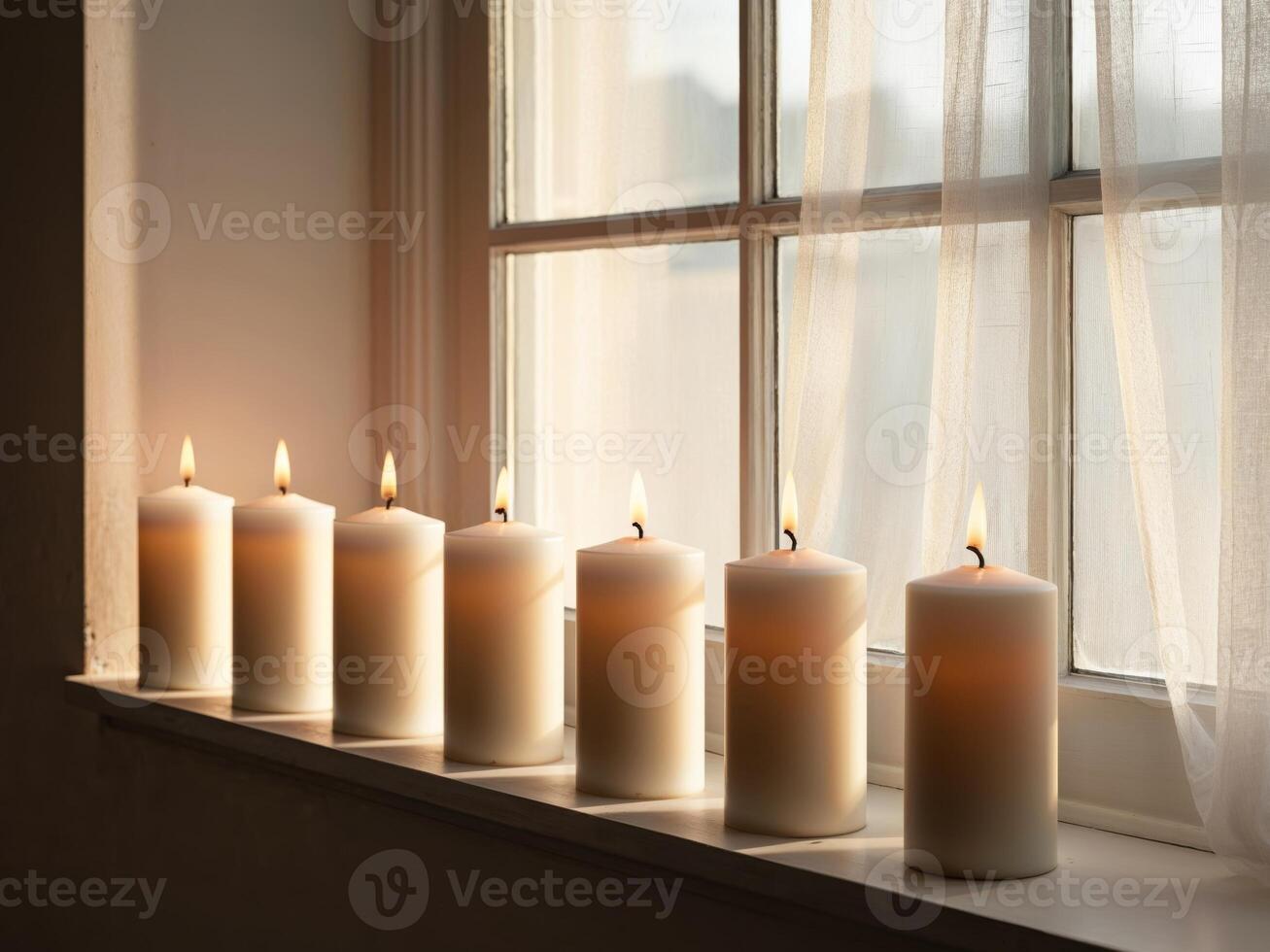 Candles in a row on a window sill photo