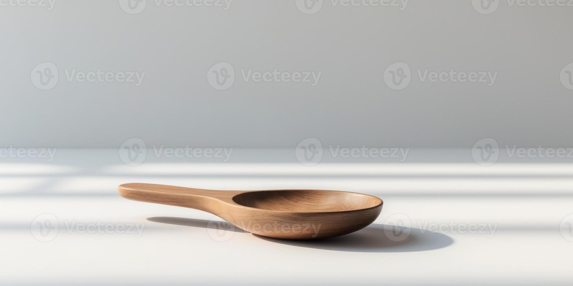 A wooden spoon is sitting on a white surface photo
