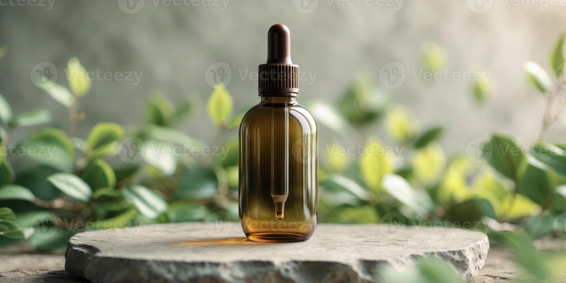 Brown glass dropper bottle on stone with green foliage background photo
