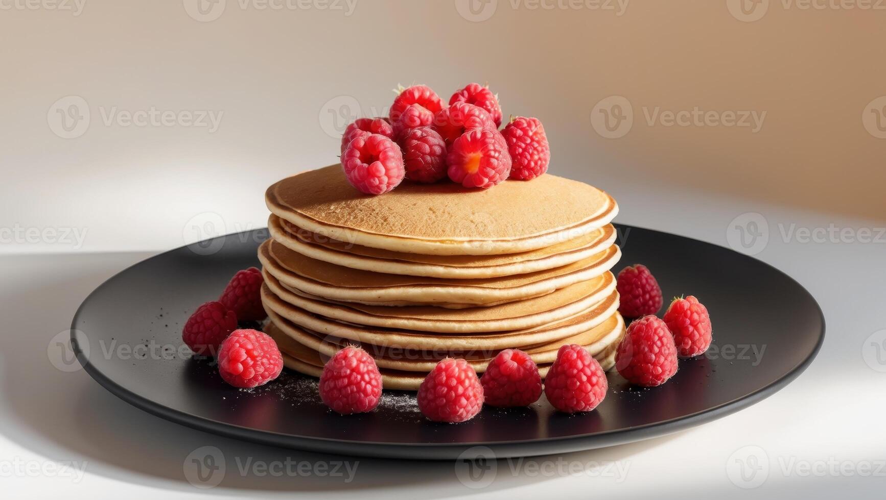 A stack of pancakes with raspberries on top photo