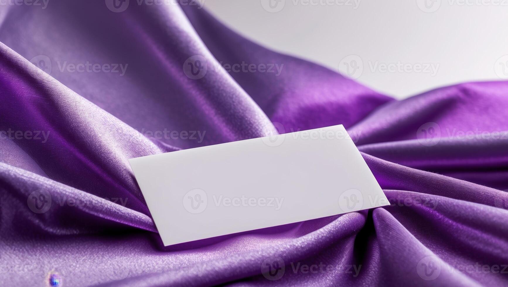 A white card on a purple satin fabric photo