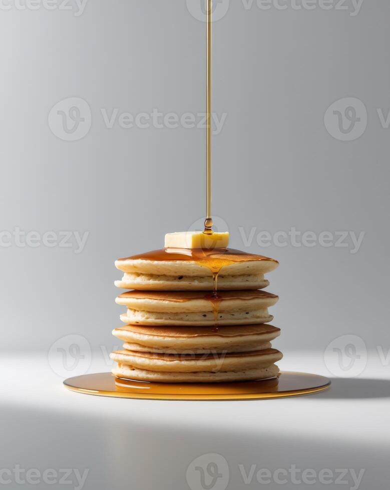 A Stack of Golden Brown Pancakes Drizzled with Sweet Syrup and Topped with a Pat of Melted Butter photo