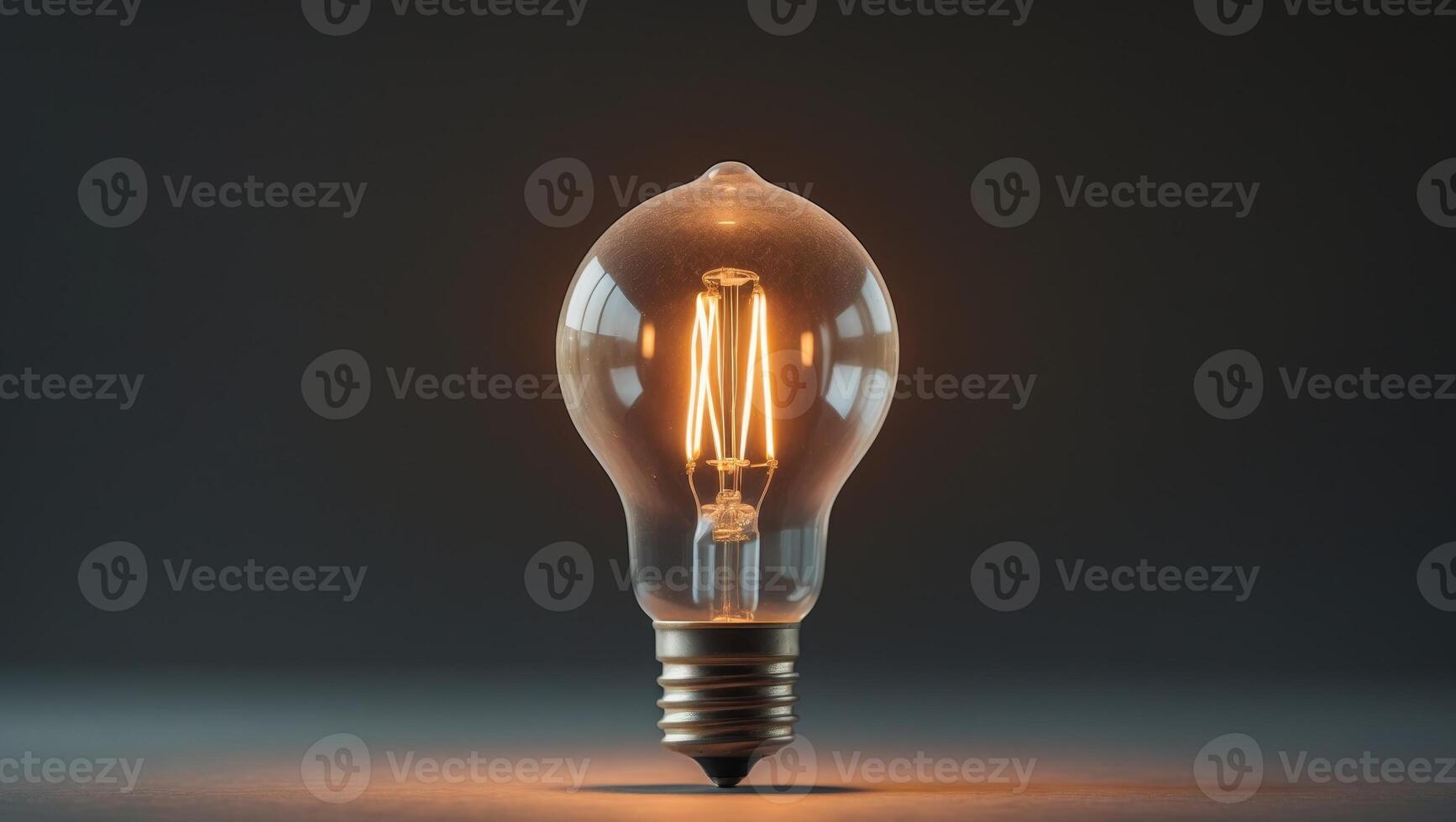 Glowing vintage light bulb illuminating dark background photo