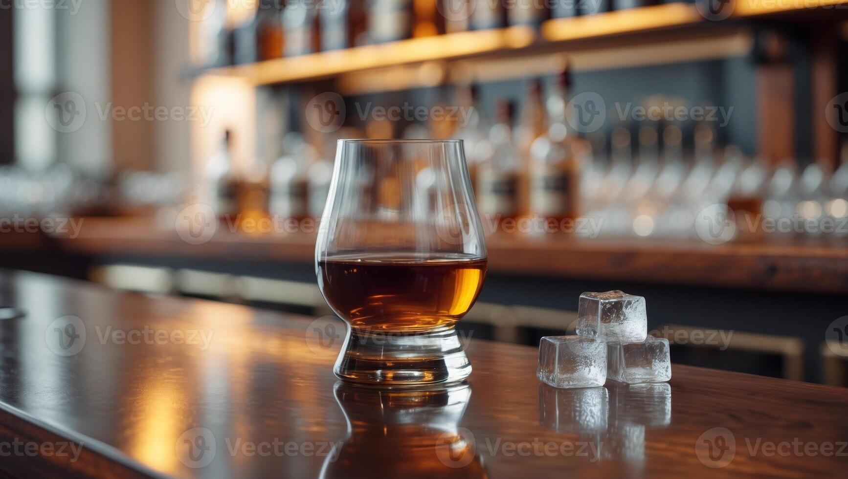 Classic whisky glass with ice in elegant bar setting photo