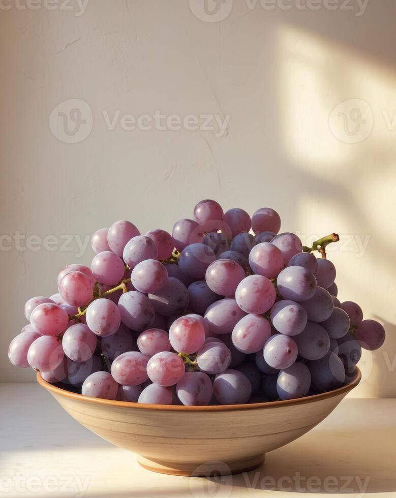 A bowl of grapes sitting on a table photo