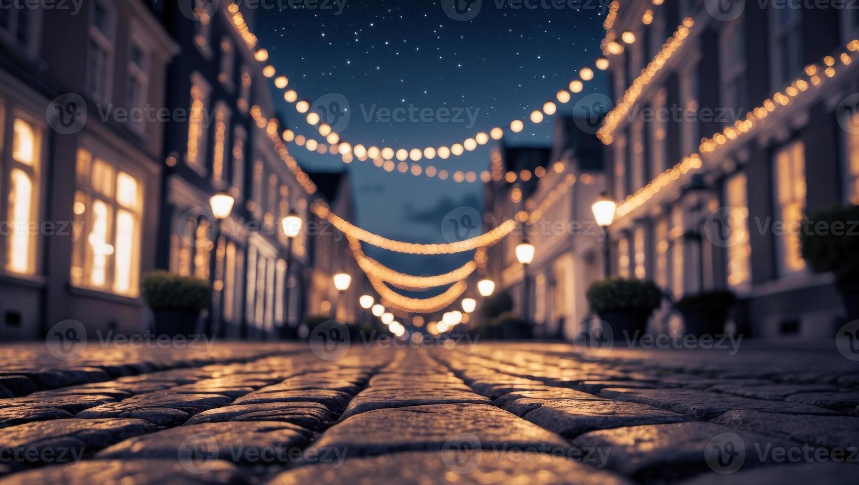 Nighttime View of a Cobblestone Street with Building Facades and String Lights photo