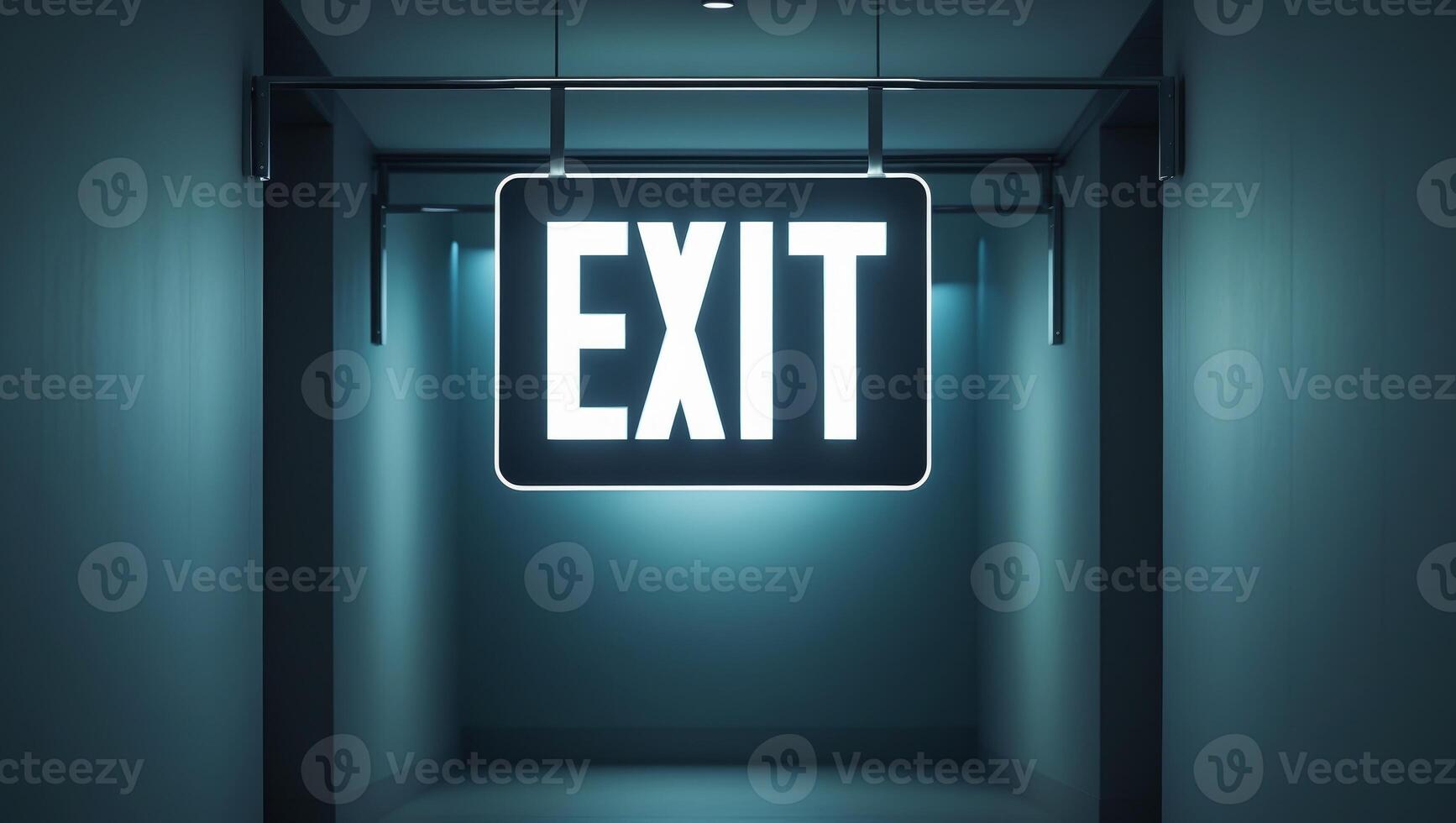 Illuminated exit sign with brackets in dark hallway photo