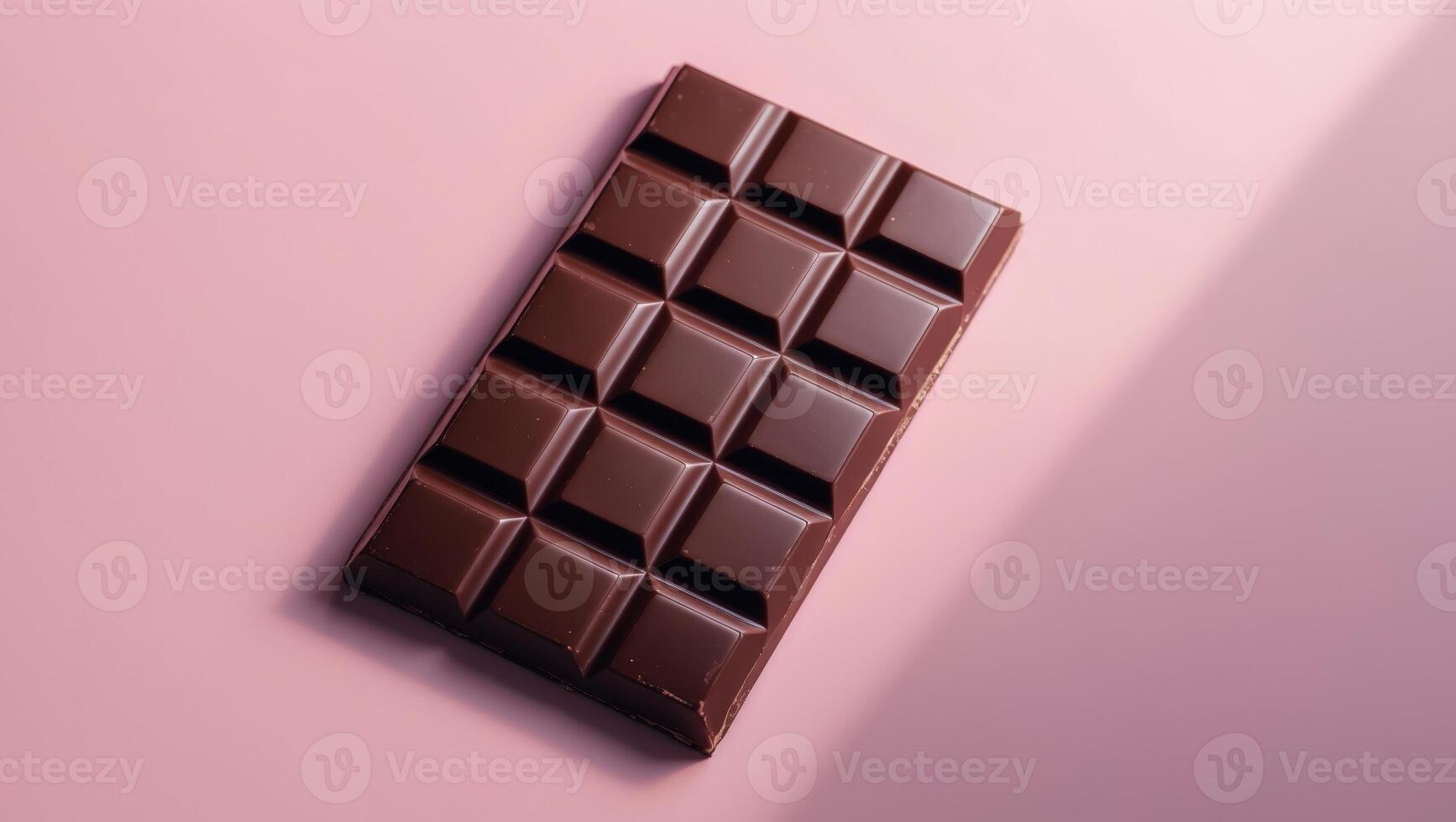 Smooth Dark Chocolate Bar on Pink Background with Glossy Finish photo