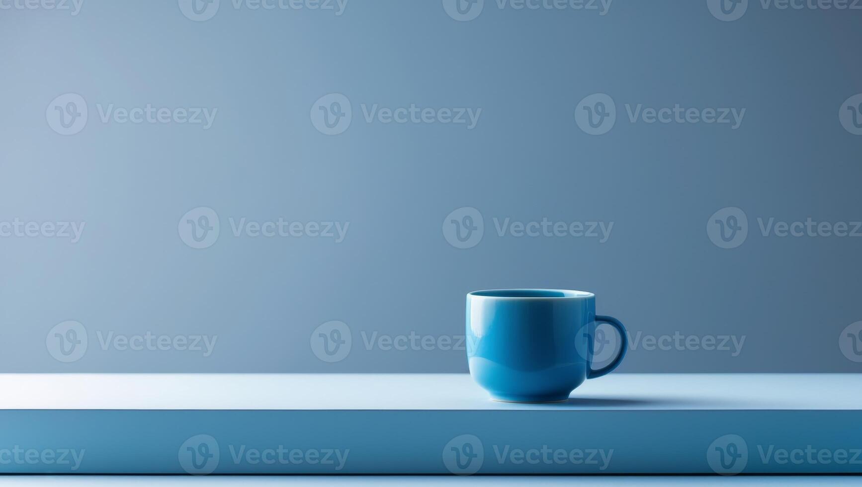 there is a blue cup sitting on a table with a blue background photo