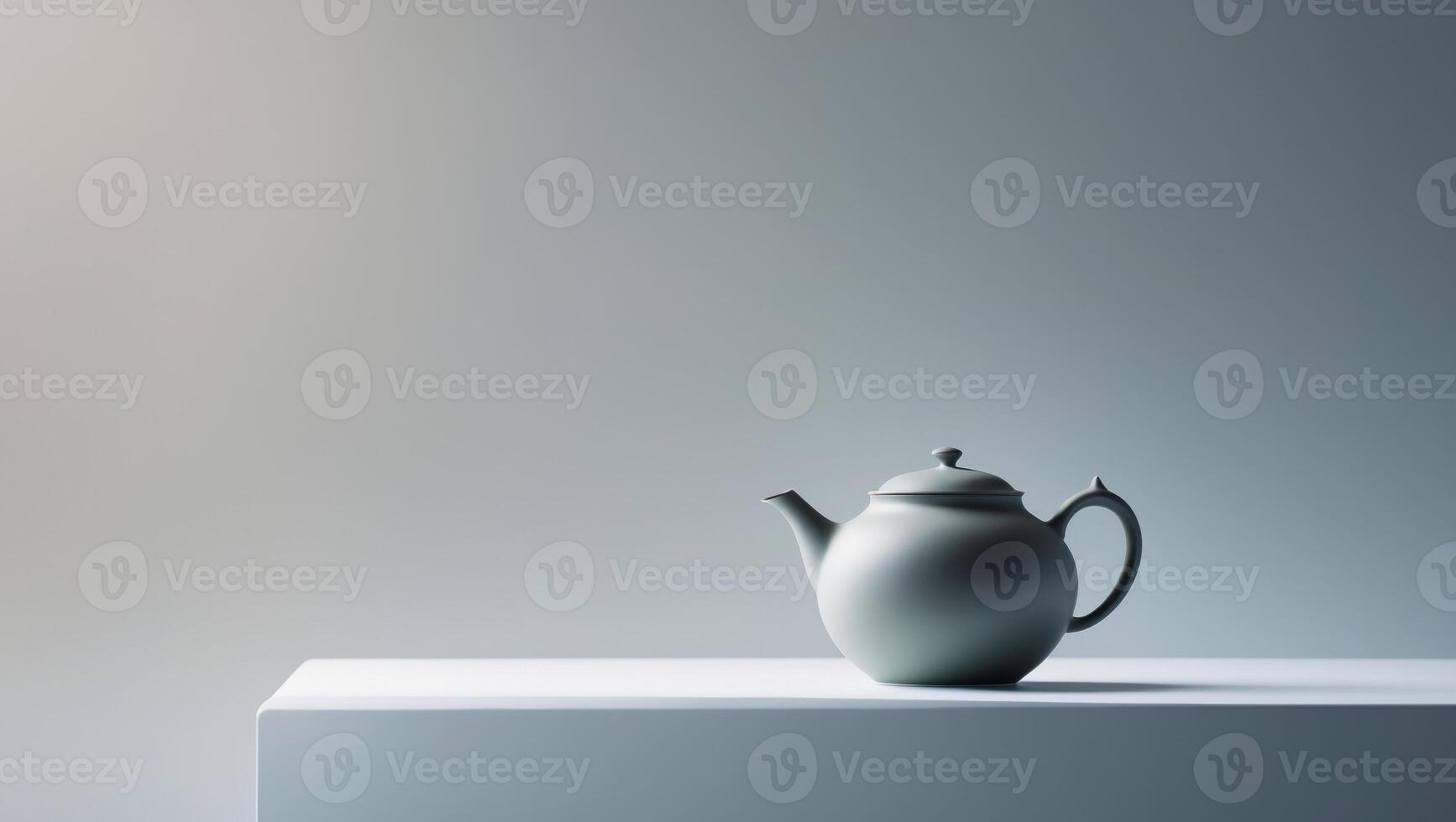 A teapot is sitting on a white table photo