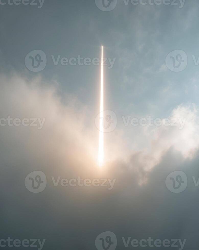 A single beam of light shining through the mist and cloud photo